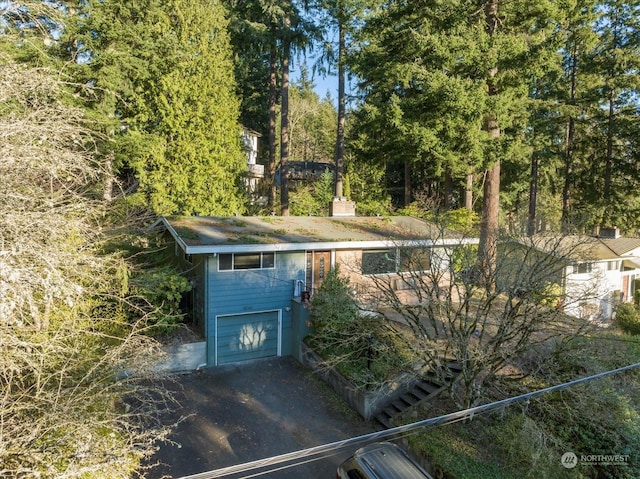 view of outbuilding featuring a garage and driveway