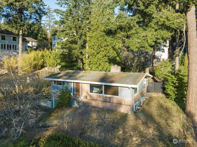 exterior space with a chimney and fence