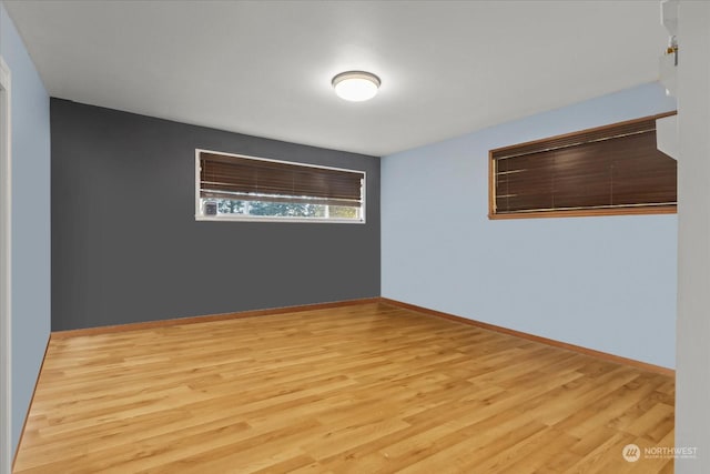 empty room featuring baseboards and wood finished floors