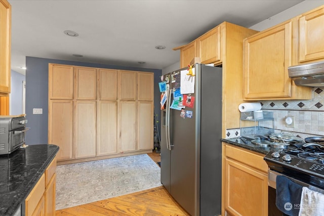 kitchen with appliances with stainless steel finishes, light brown cabinets, and light wood finished floors