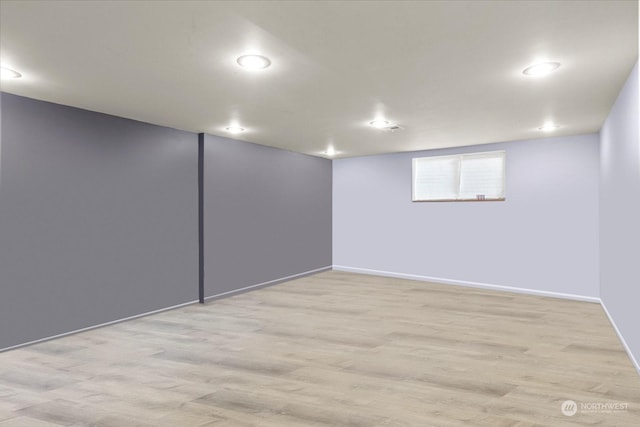 basement featuring recessed lighting, baseboards, and wood finished floors