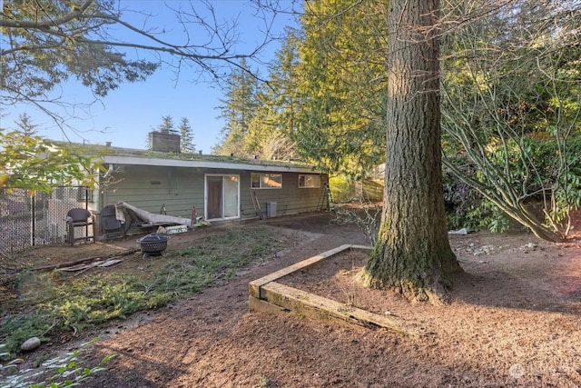 rear view of property with fence and a chimney