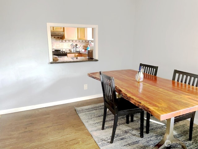 dining room with wood finished floors and baseboards