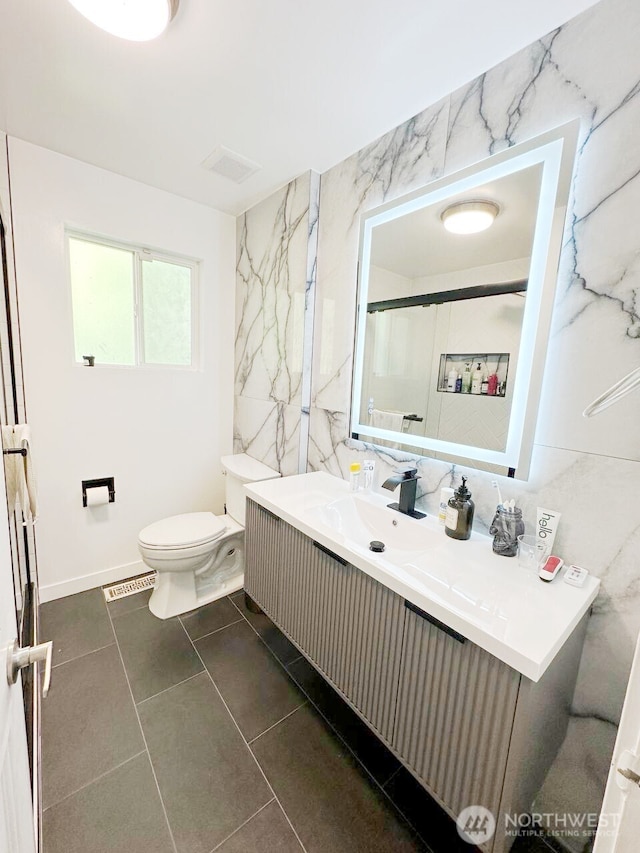 bathroom with visible vents, toilet, tile walls, and vanity