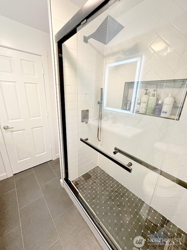 bathroom featuring tile patterned flooring and a stall shower