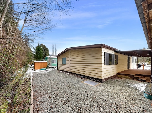 view of property exterior with a deck