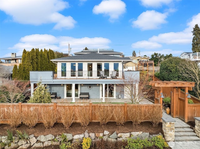 back of house featuring a balcony