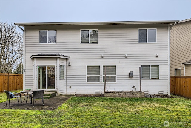 back of house featuring crawl space, a fenced backyard, and a yard