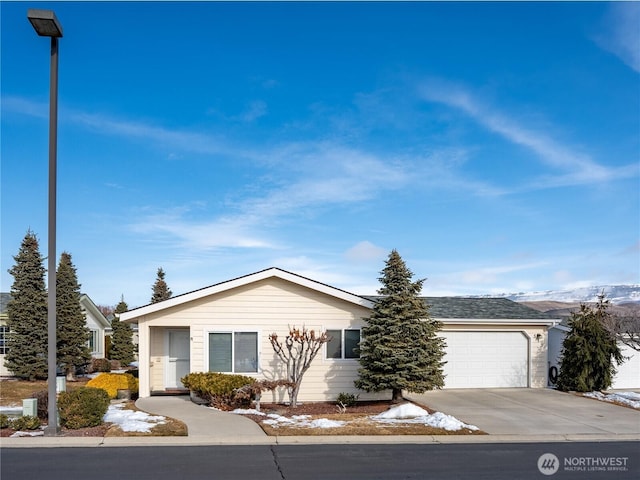 single story home with a garage and driveway