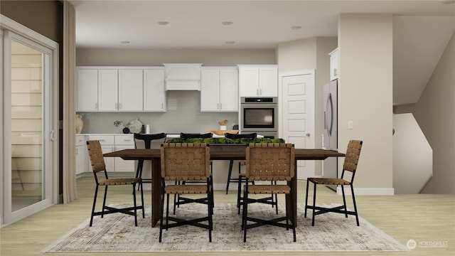 kitchen featuring white cabinetry, fridge, decorative backsplash, and light hardwood / wood-style flooring