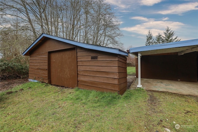 view of outbuilding featuring a yard