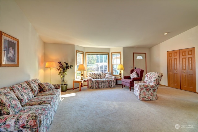 carpeted living room with vaulted ceiling