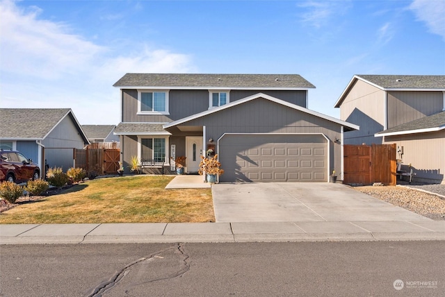 view of front property featuring a garage and a front yard