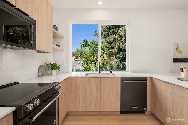 kitchen featuring range with electric cooktop, tasteful backsplash, sink, light hardwood / wood-style floors, and light brown cabinets