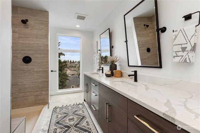 bathroom featuring walk in shower and vanity