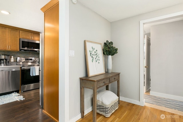 hallway with hardwood / wood-style flooring