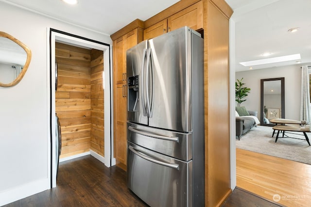 kitchen with dark hardwood / wood-style flooring and stainless steel fridge with ice dispenser