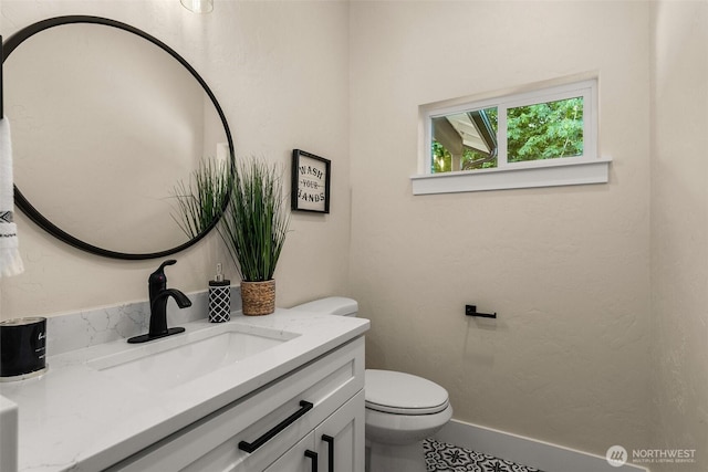 bathroom with toilet and vanity