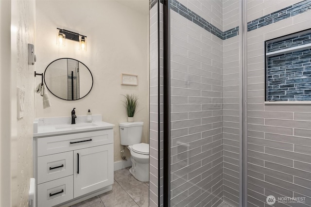 bathroom with vanity, an enclosed shower, toilet, and tile patterned floors