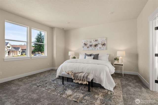 bedroom with dark colored carpet