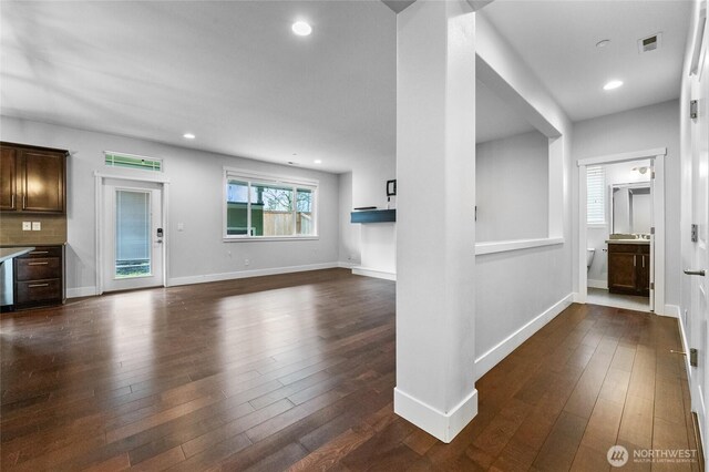 unfurnished living room with recessed lighting, visible vents, and dark wood-style flooring