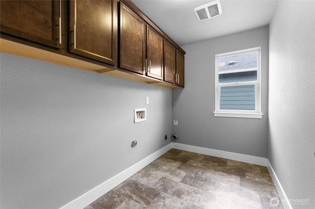 washroom featuring hookup for a washing machine, cabinet space, visible vents, and baseboards