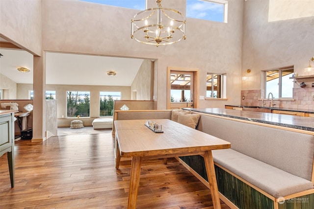 dining area featuring sink, hardwood / wood-style flooring, and plenty of natural light