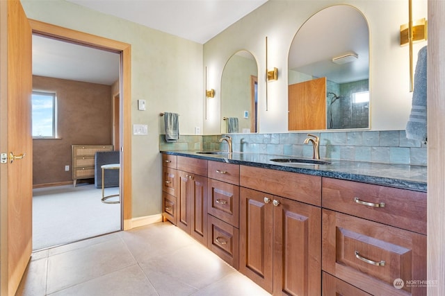 bathroom featuring tasteful backsplash, tile patterned floors, and vanity