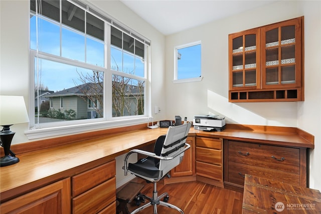 office area featuring wood finished floors and built in desk