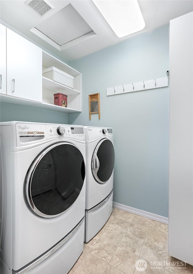 laundry area featuring light tile patterned floors, washing machine and dryer, visible vents, and baseboards