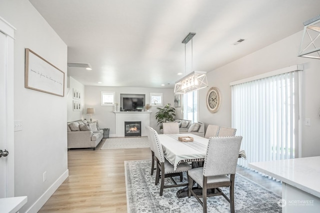 dining space featuring light wood-type flooring