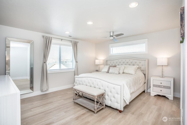 bedroom with ceiling fan, multiple windows, and light wood-type flooring