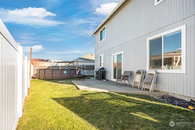 view of yard with a fenced in pool and a patio