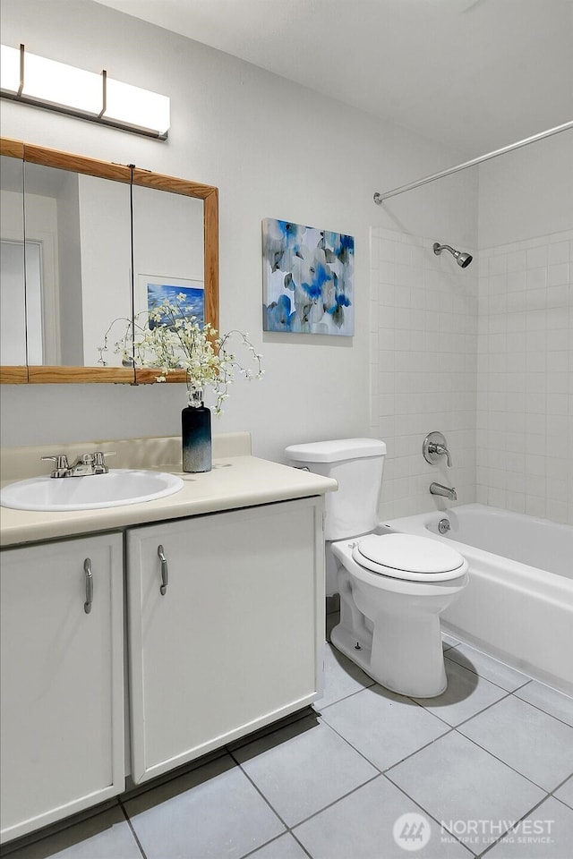 full bathroom featuring bathtub / shower combination, tile patterned flooring, a sink, and toilet