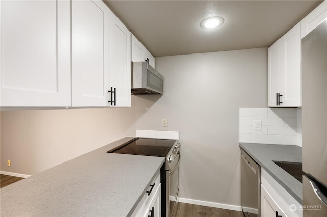 kitchen featuring white cabinetry, appliances with stainless steel finishes, backsplash, and dark hardwood / wood-style flooring