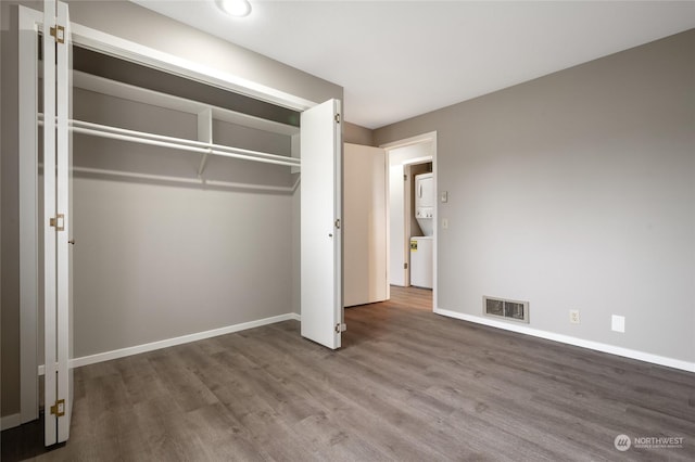 unfurnished bedroom featuring hardwood / wood-style floors and a closet