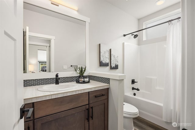 full bathroom with shower / bath combination with curtain, backsplash, hardwood / wood-style flooring, vanity, and toilet