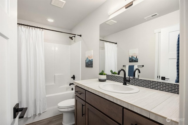 full bathroom with shower / tub combo, vanity, wood-type flooring, and toilet