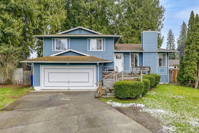 tri-level home with a garage and a front lawn