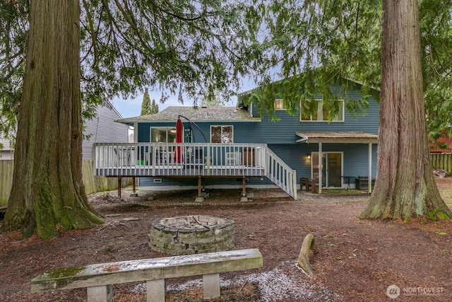 view of front of property with a wooden deck and a fire pit