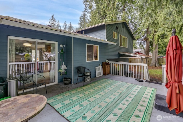 wooden terrace with a patio area