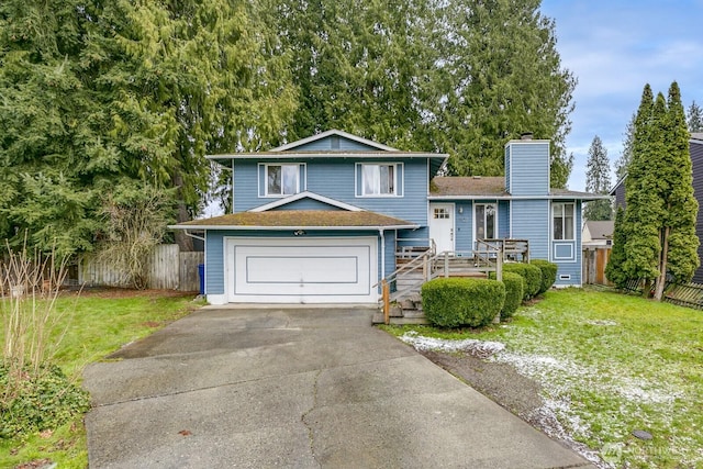 view of front of property featuring a garage and a front lawn