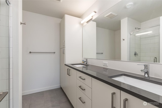 bathroom with vanity and a shower with door