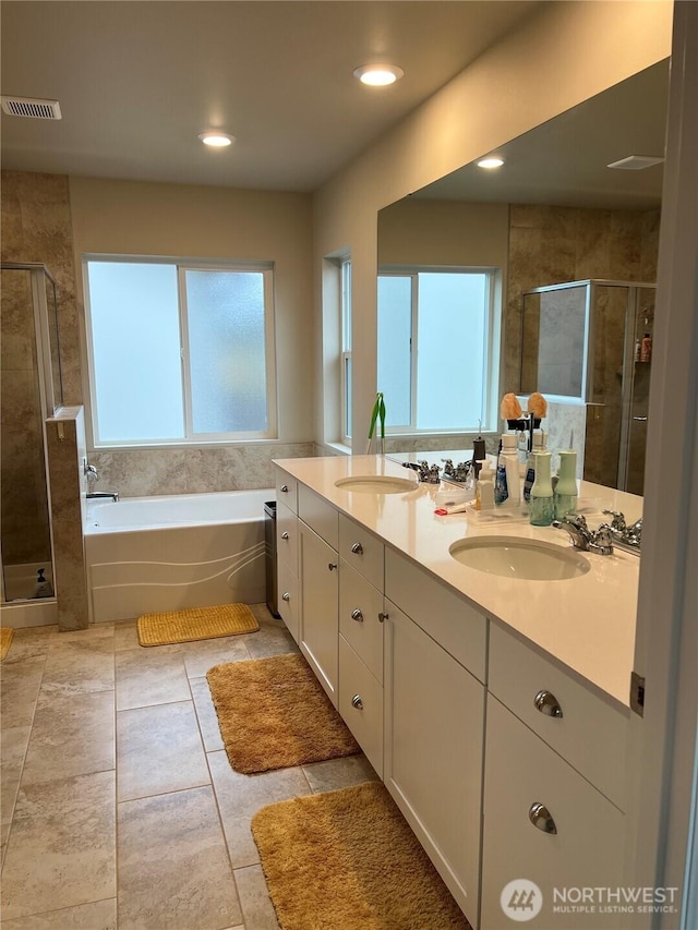 bathroom featuring vanity and plus walk in shower