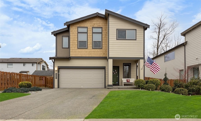 modern home with a garage, driveway, a front yard, and fence