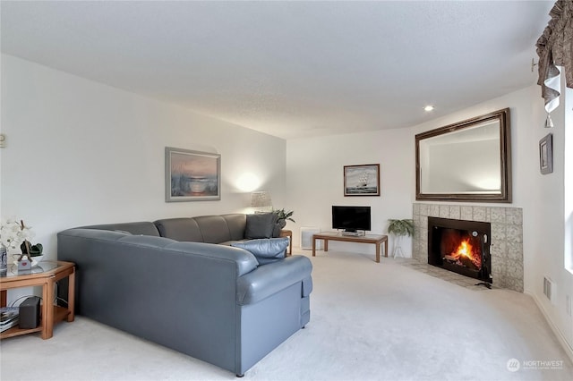 living room featuring a fireplace and carpet