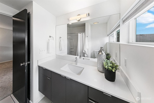 bathroom featuring walk in shower and vanity