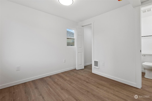 unfurnished room with hardwood / wood-style flooring