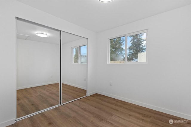 unfurnished bedroom featuring hardwood / wood-style flooring and a closet