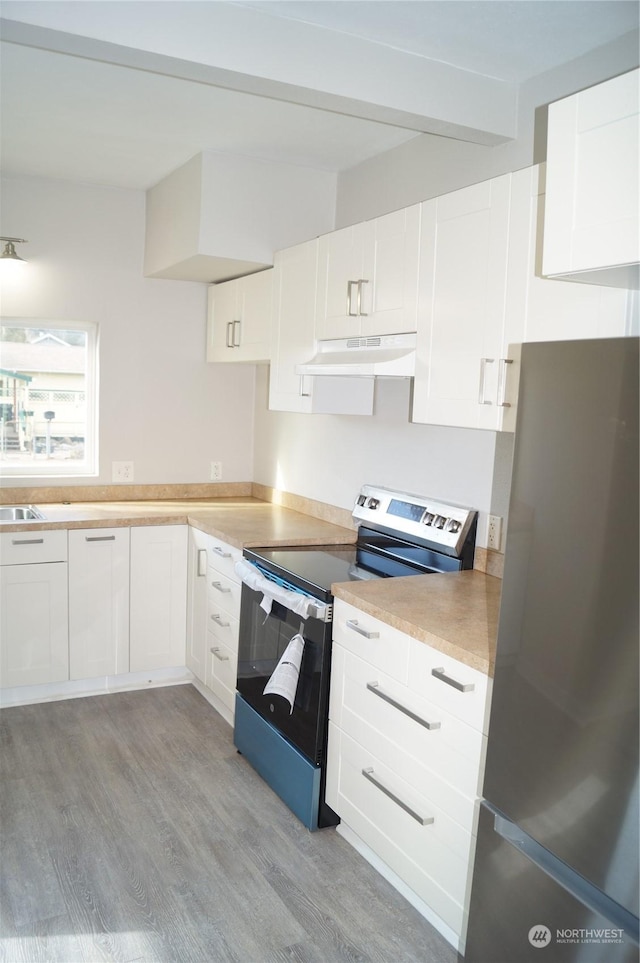 kitchen featuring white cabinetry, appliances with stainless steel finishes, and light wood-type flooring